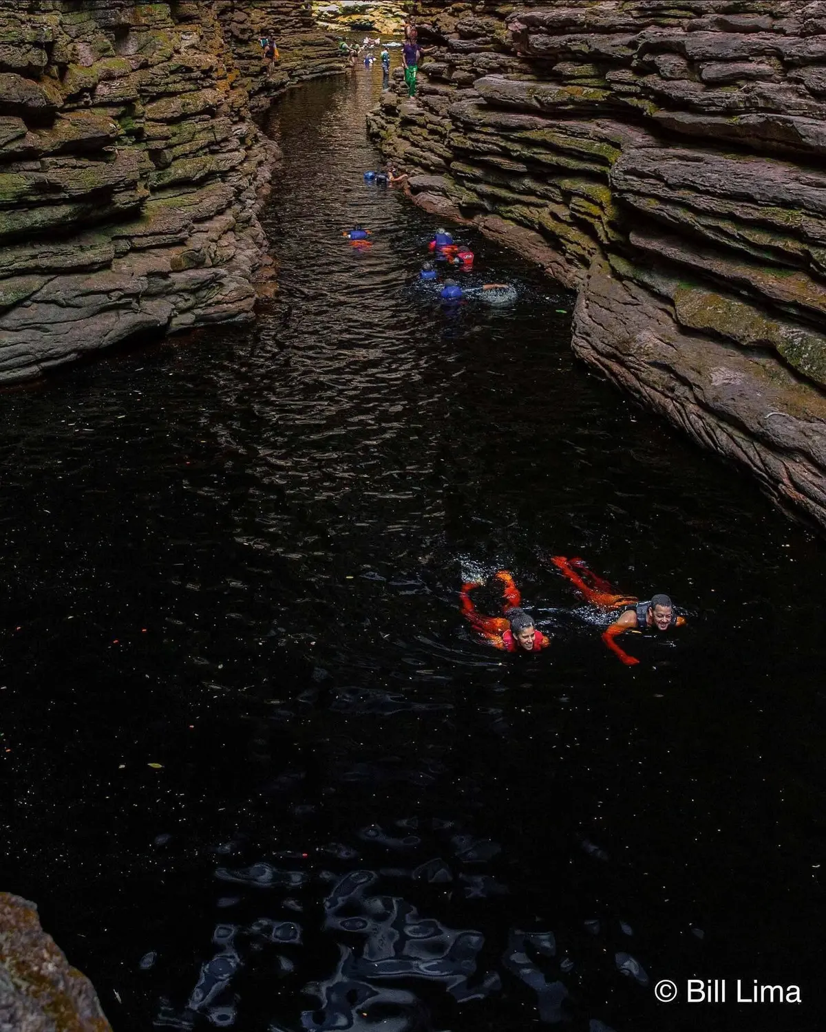 Group swimming in life vests through the Buracão canyon