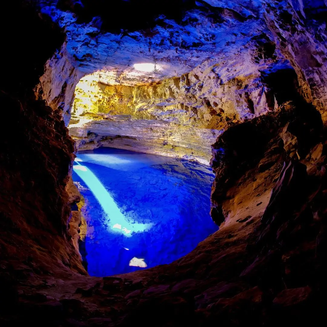 Beam of blue light crossing the clear water at the bottom of Poço Encantado