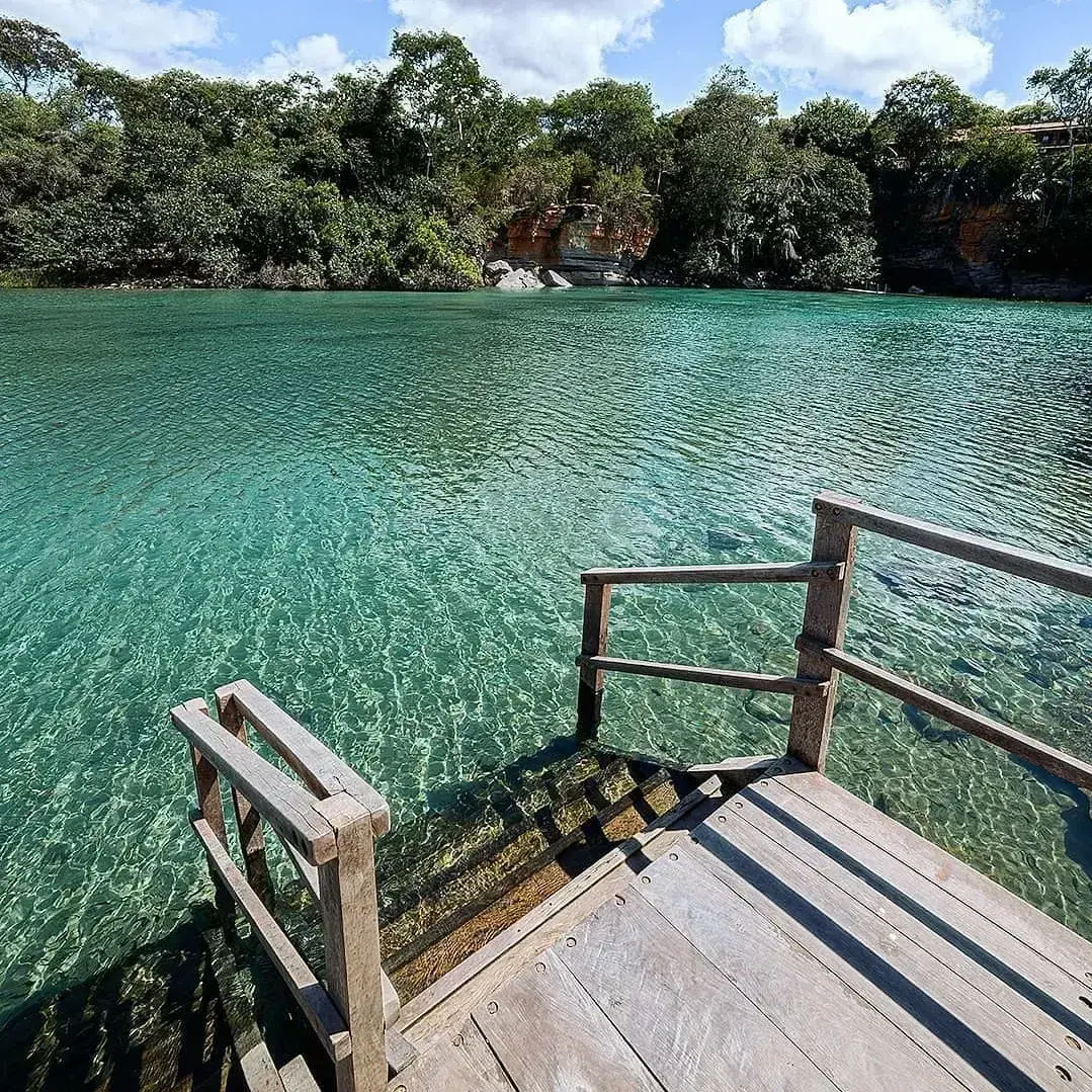 Wooden deck with steps going down to the turquoise water of the Pratinha River